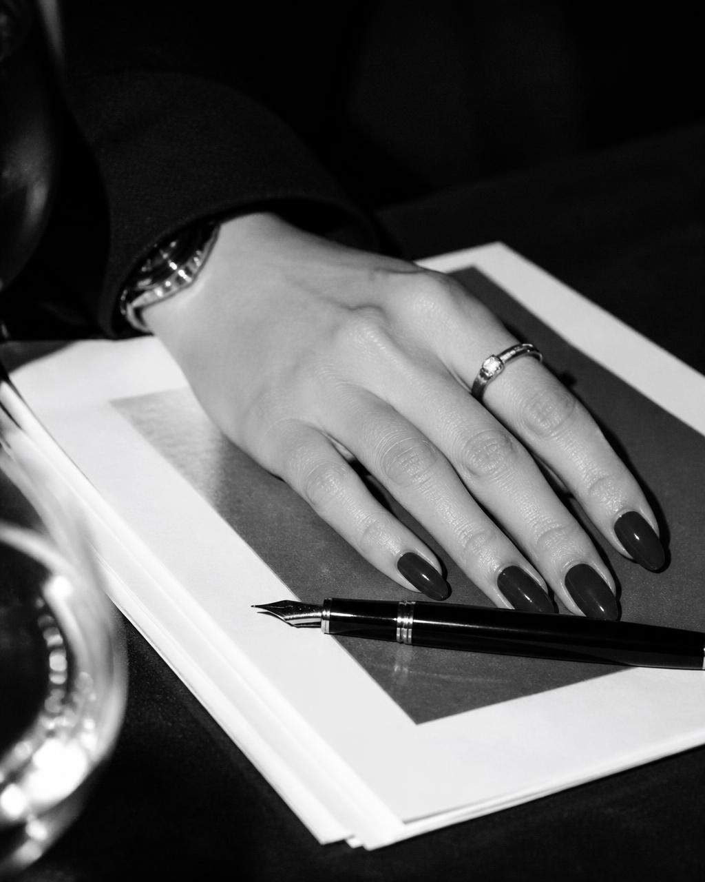 Close-up of a hand resting on printed strategy documents