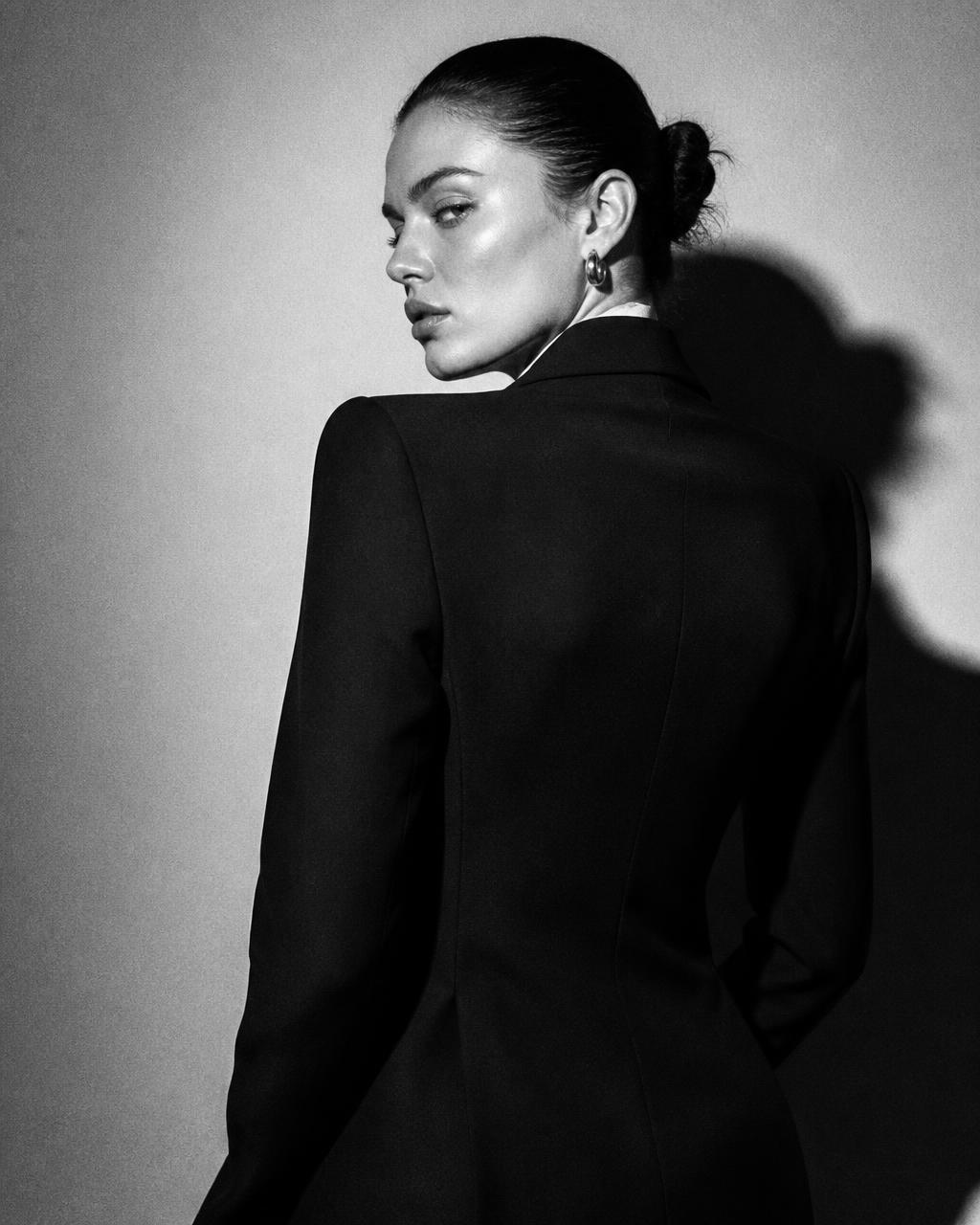 Editorial portrait of a woman in a tailored blazer